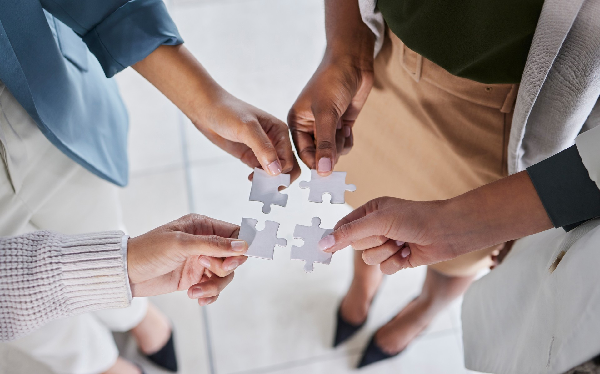 Top view, puzzle and hands with business, partnership or planning for new project, teamwork or staff. Team, group or jigsaw with collaboration for innovation, career success or brainstorming together